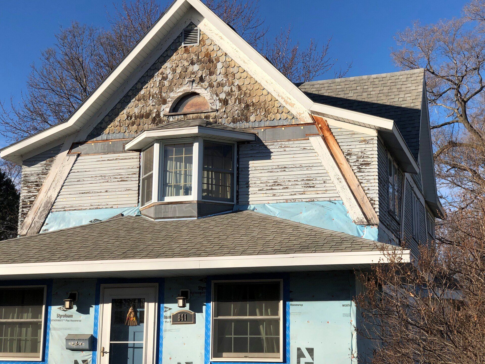 House before siding replacement — old worn siding